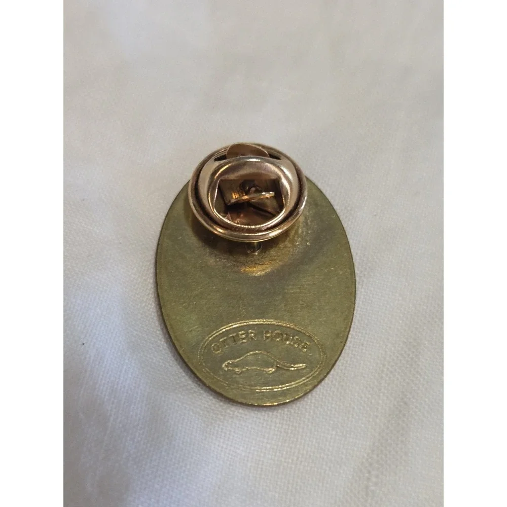 vintage Otter House lapel pin featuring a portrait of a black poodle